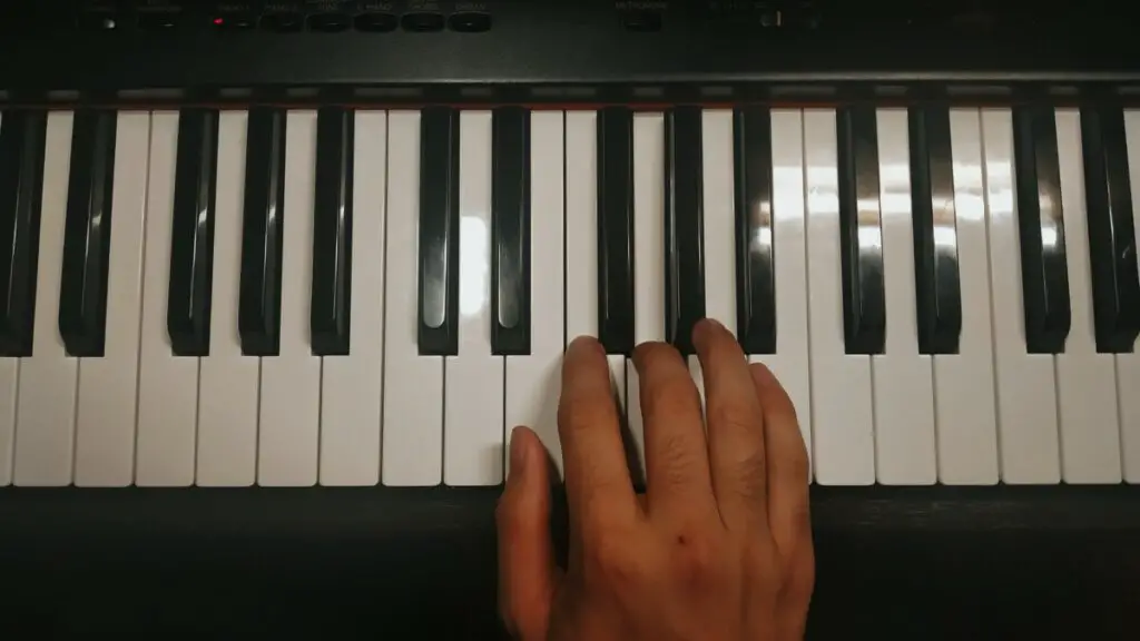 Picture of a hand on a piano