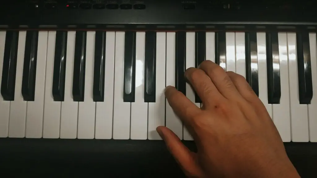 Picture of a hand on a piano